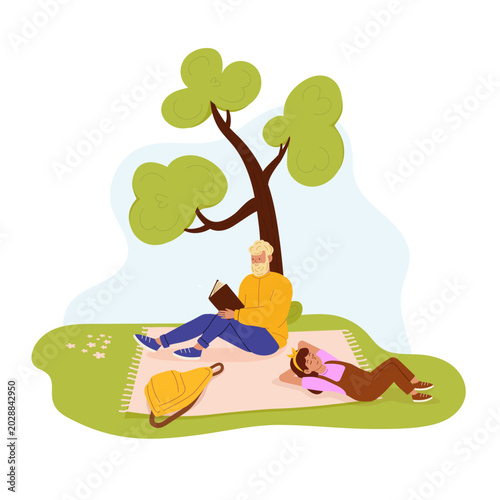 Father reading book to his daughter sitting under tree on blanket. Parenting, family bonding, outdoor education, storytelling.