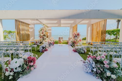 Luxury Beachfront Wedding Ceremony Setup With Floral Decorations and Ocean View Destination Venue