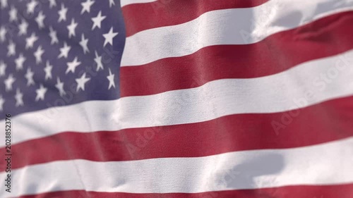 Seamless looping animation of the USA flag waving in the wind. Ultra-realistic fabric texture with detailed cloth movement. High-quality 4K resolution. Ideal for patriotic backgrounds