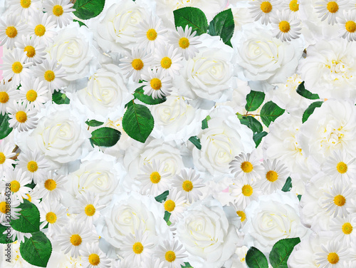 A close-up shot showcases a vibrant arrangement of white roses and daisies. Green leaves are interspersed throughout the floral display.
