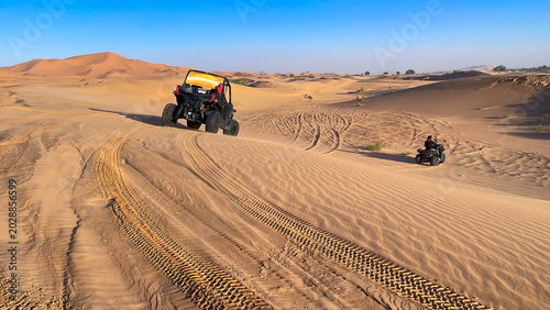 Fotografie first person point of view from a buggy following a UTV and a quad bike driving
