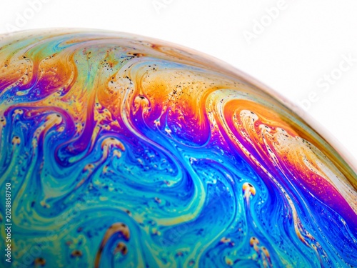 Macro Iridescent Soap Bubble Texture with Rainbow Colors on White Background;