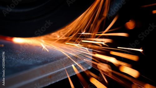 Принти на полотні Extreme macro shot of grinding sparks streaking directly toward the camera from a steel surface