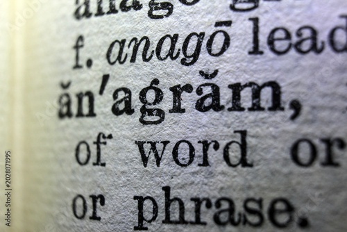 Foto Word anagram on dictionary page, macro close up