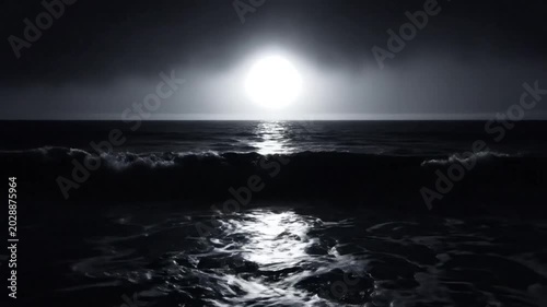 Mysterious monochrome moon shining brightly across a dark ocean with undulating waves under a cloudy night sky