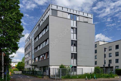 Exterior view of a transitional home for refugees and resettlers on Oskar-Jäger-Strasse, Cologne. Repurposed modern office complex for housing