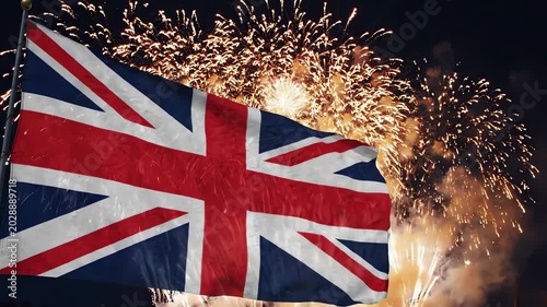 British Flag Waving on Flagpole with Festive Fireworks Exploding in Night Sky Backdrop
