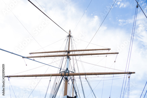 Foto Sailboat Mast and ropes with cloudy blue sky background