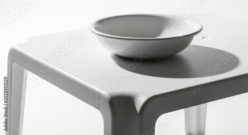 Empty white ceramic plate and coffee cup on a modern kitchen table with a clean minimalist interior nobody present