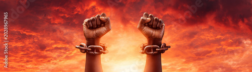 Juneteenth freedom fist raised hand chain broken slavery abolition sunset sky