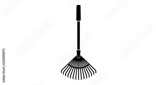 Konstfotografi Black garden rake with long handle.