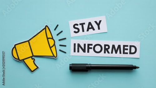 Stay informed text with megaphone cutout and marker on blue background