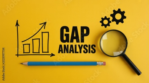 Gap analysis concept with bar chart, magnifying glass, pencil, and gears