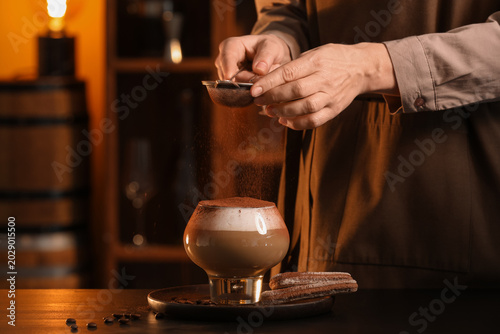 Female bartender with sieve...