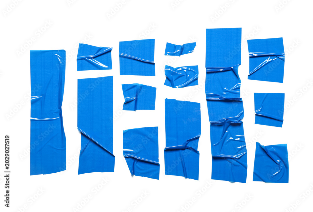 Fototapeta premium Crumpled strips of blue adhesive tape on white background