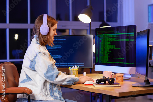Happy female programmer wit...