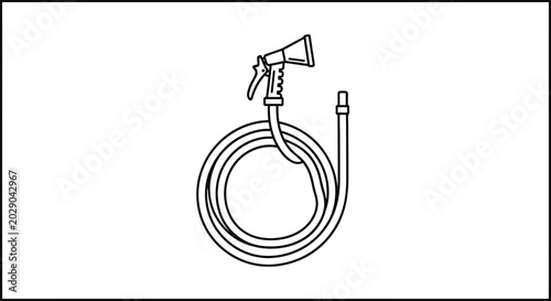 Quadro su tela Coiled garden hose with spray nozzle.