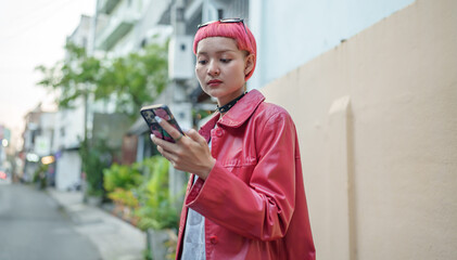 Traveler Gen z girl leather fashion with punk Asian woman tourist in city street searching location in map application online smart phone using GPS navigating