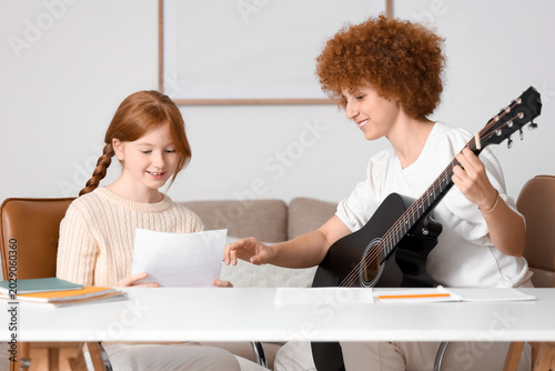 Young woman with notes givi...
