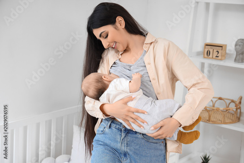 Young woman breastfeeding h...