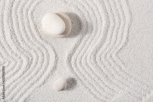 Stones on sand with lines i...