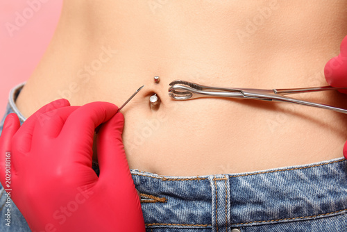 Professional doing piercing...