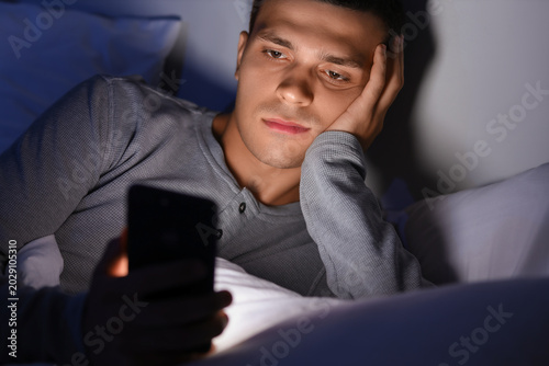 Young man using mobile phon...