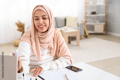 Young Muslim woman working ...