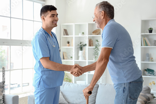 Male nurse with senior man ...