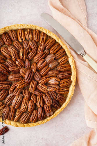 Tasty pecan pie on light ba...