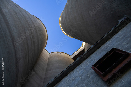 Fotografia Looking up between old grain silos