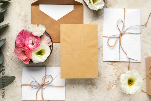 Fotografija Composition with envelopes, blank cards and eustoma flowers on beige background