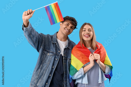 Young couple with LGBT flag...