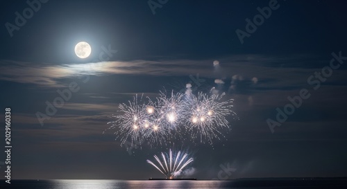White fireworks display over dark ocean under a full moon