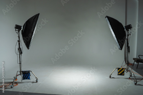 Creative workspace backdrop for commercial advertising photoshoot production and media design. Blank stage with studio flashlights symbolizing preparation new beginning and artistic freedom