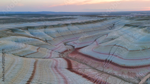multicolored canyon at sunset Kyzylkup is a natural landmark in the Mangystau region of Kazakhstan. It is a group of colorful hills with multicolored layered slopes that resemble