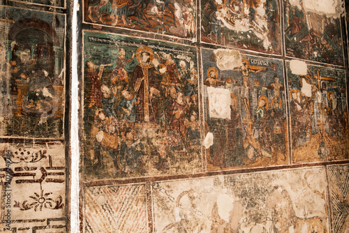 Фотография Detailed view of the ancient and vibrant biblical frescoes decorating the rock-c