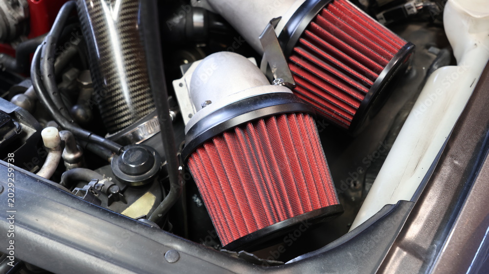 Naklejka premium Close up of engine bay with aftermarket red performance cone air intake filters
