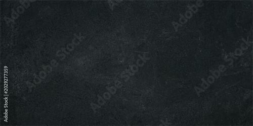 Fotografia A dark, textured surface with subtle highlights and shadows creates a mysterious and sophisticated backdrop