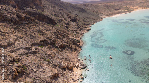 Bild auf Leinwand Aerial Rocky Desert Coastline with Turquoise Sea. Sokotra, Yemen.