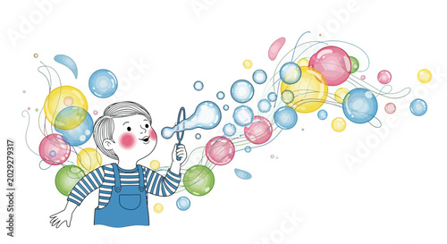 Happy little boy blowing colorful bubbles outdoors