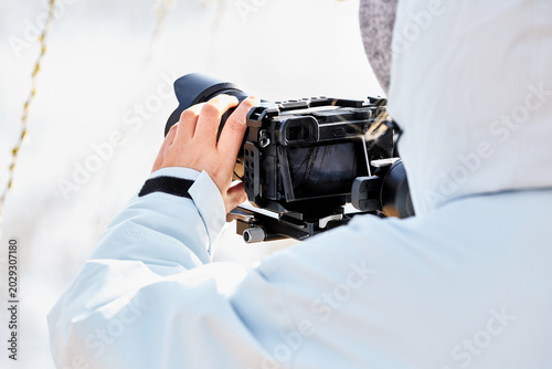 Tableau sur toile Cameraman using handheld camera gimbal stabilizer for outdoor video shooting
