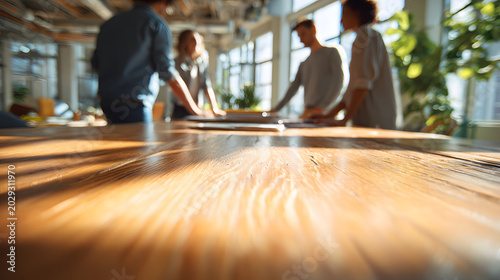 Wooden table sunlight team collaboration meeting modern office bright workspace planning discussion