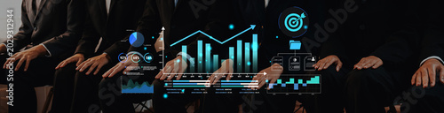 Fotografia Business professionals engaging in a data analysis discussion with digital graphics displaying growth metrics and performance indicators in a modern office setting Haptic