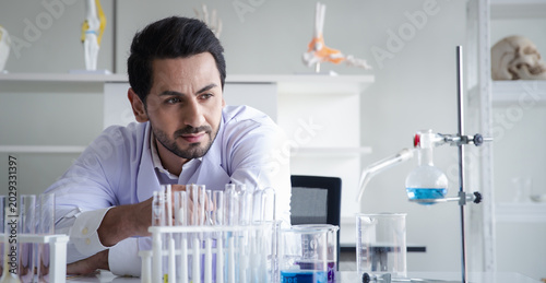 Scientist man laboratory glassware experiment research chemistry analysis focused scientist man laboratory glassware experiment research chemistry