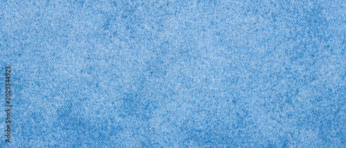 Blue denim fabric texture with melange weave for a fashion jeans background