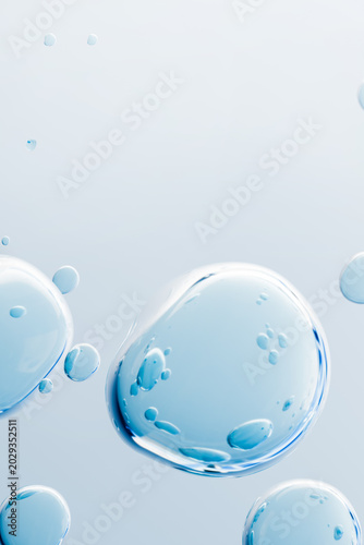 Fotografie Floating blue transparent bubbles with liquid texture on a clean light background