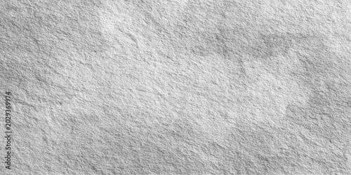 Obraz na płótnie A close-up abstract textured background of rough, uneven grey stone, revealing subtle variations in shade and surface detail