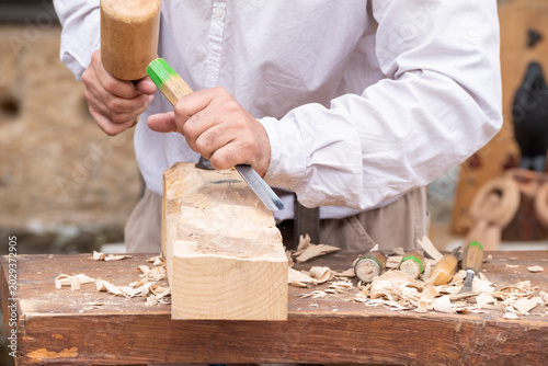 Professional carpenter carving a wooden block The Concept of manual work and focus