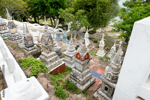 Tablou pe pânză Traditional colorful Thai Buddhist graves and stupas at a temple